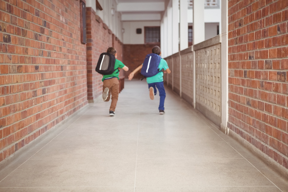 Students running down the school hall